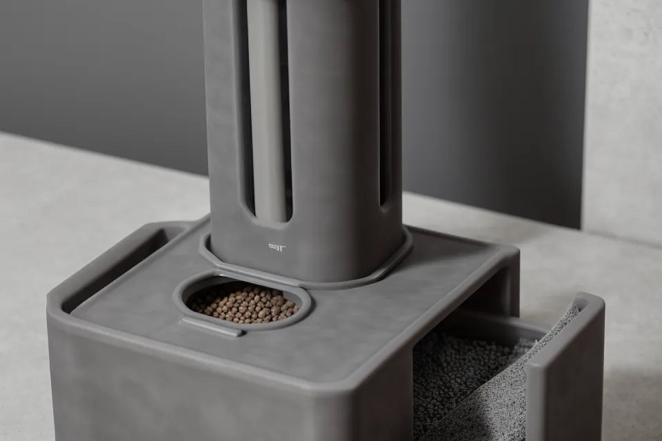Close-up of D-cell batteries being installed into the backup compartment of a pet feeder.